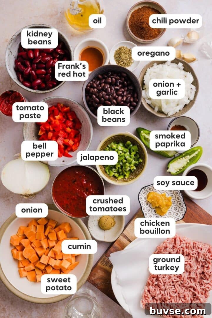 Hearty Sweet Potato Turkey Chili Recipe 3 Labeled photo of ingredients for sweet potato turkey chili, displayed in small bowls on a kitchen counter.