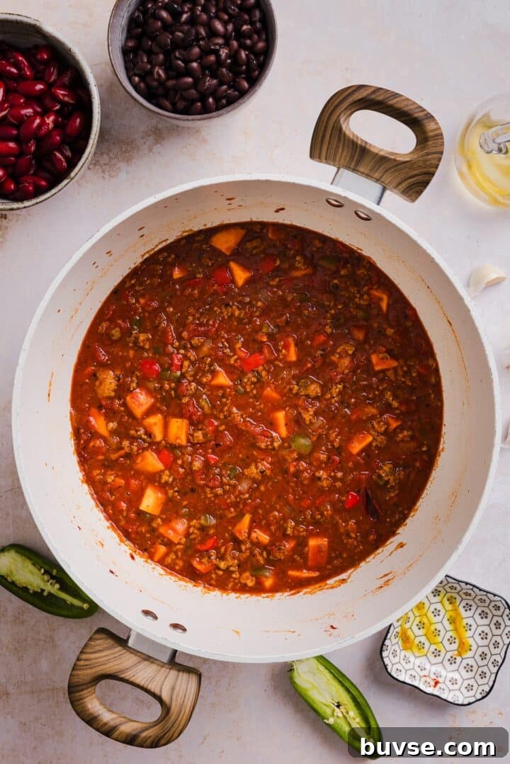 Hearty Sweet Potato Turkey Chili Recipe 5 Chili simmering in a large pot.