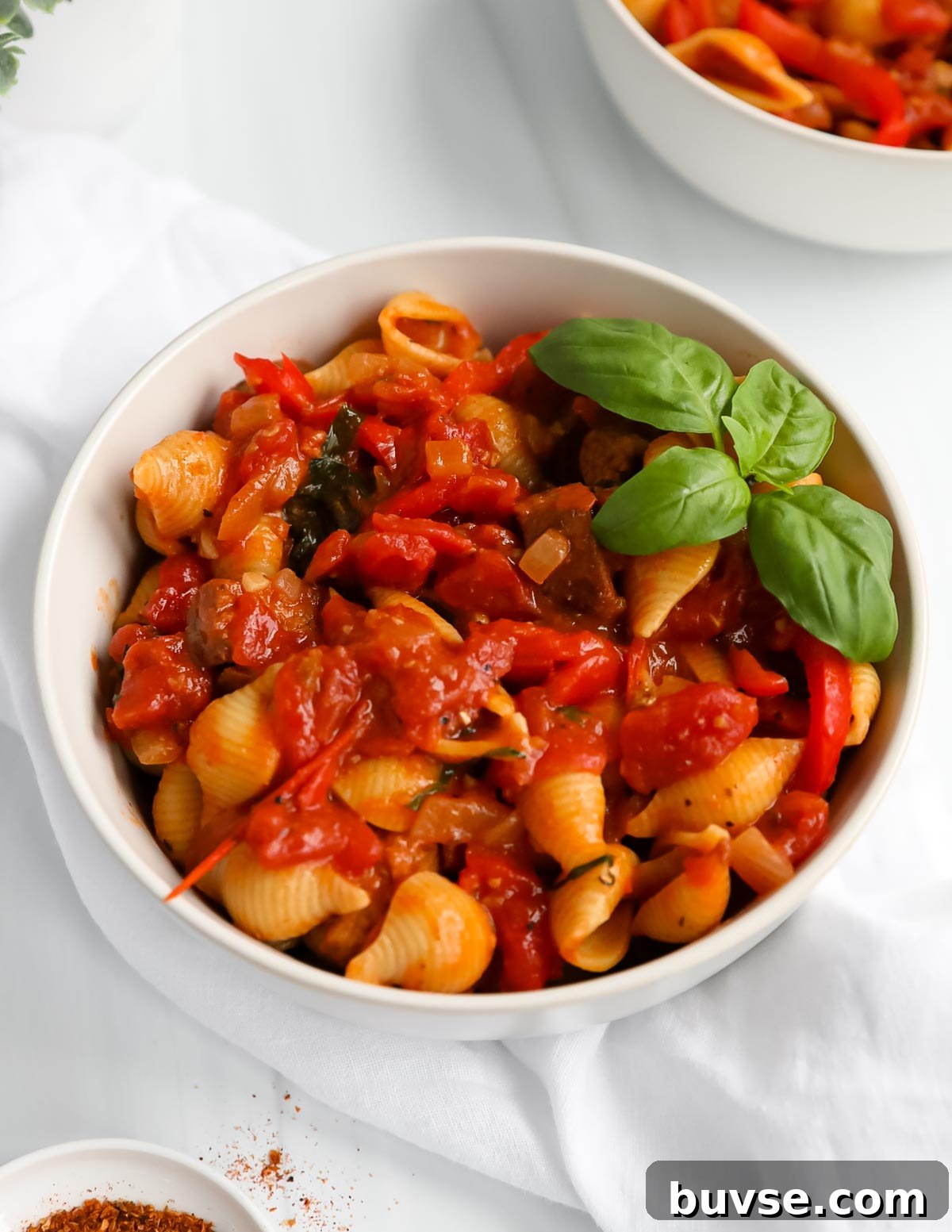 Creamy Vegan Cajun Pasta with Smoky Vegan Sausage 7 Pasta with fresh basil, tomato sauce, and sausages.