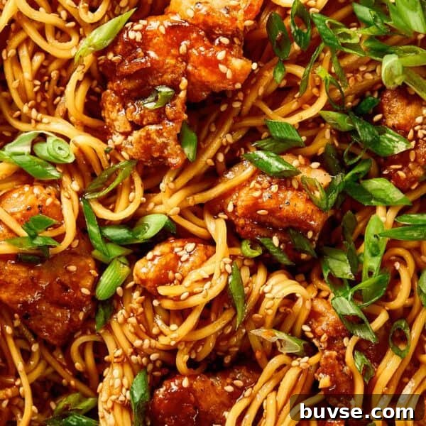 Close-up of honey sesame chicken noodles