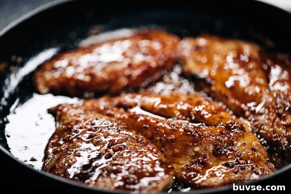 chicken simmering in hot honey glaze