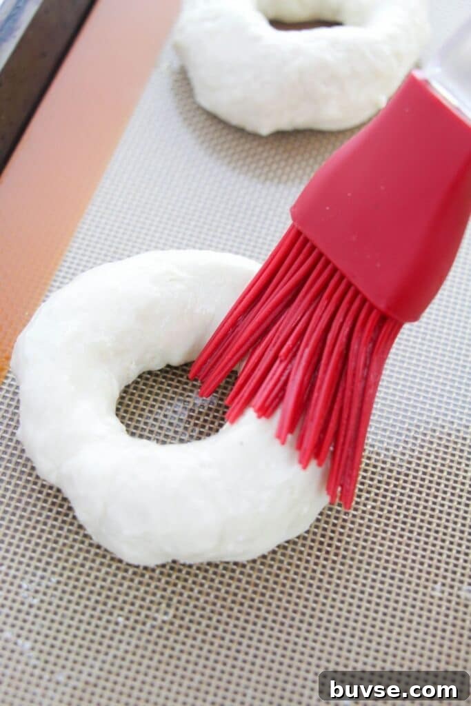 using a silicone brush for wiping egg whites on bagels