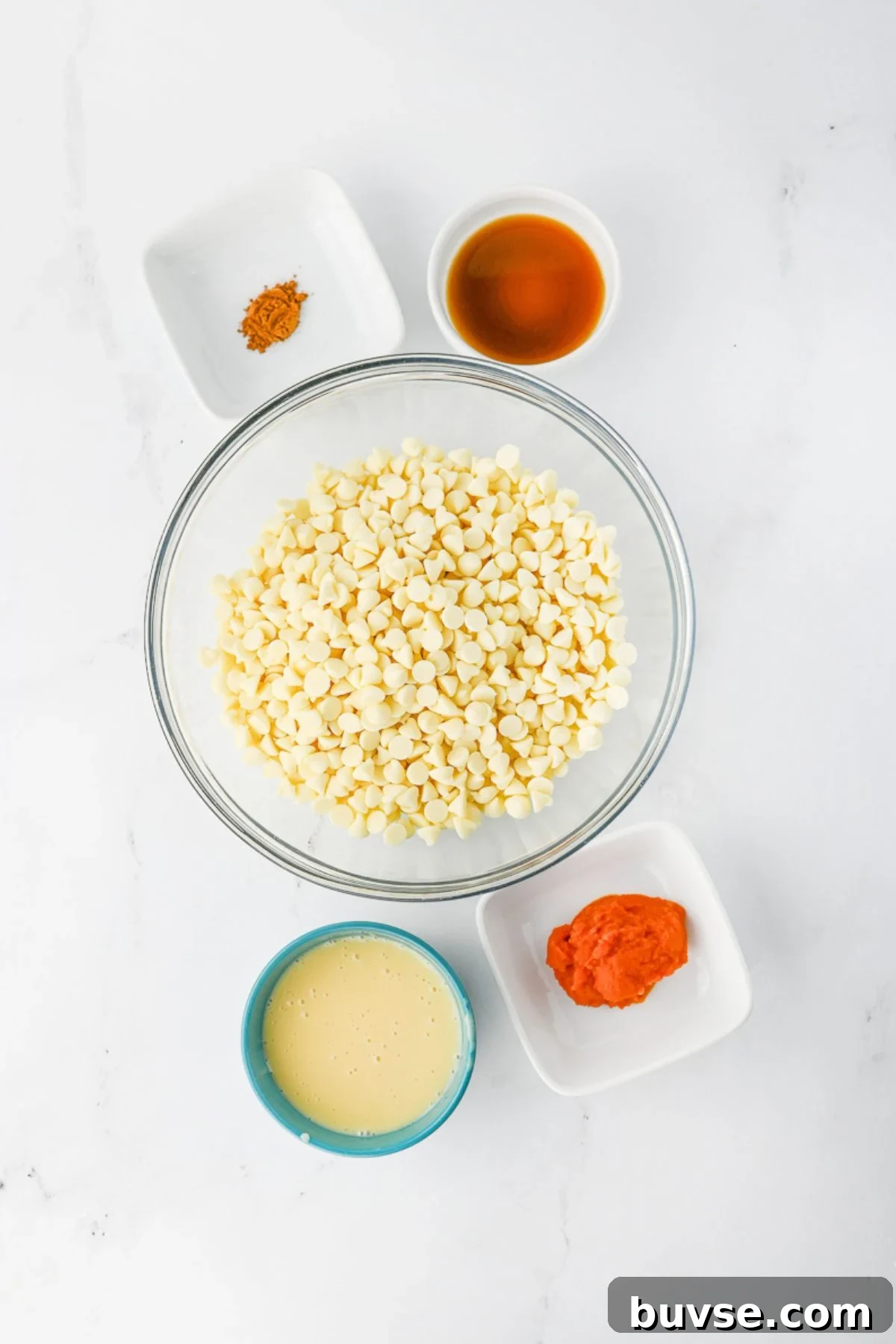 Ingredients for pumpkin fudge in small dishes sitting on counter.