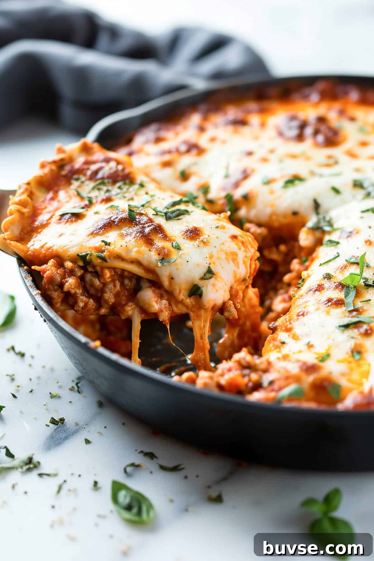 Easy skillet lasagna with ground beef in a cast iron pan.