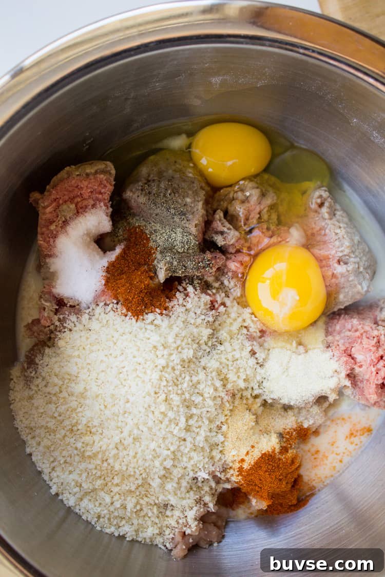 meatball ingredients in a large metal bowl.