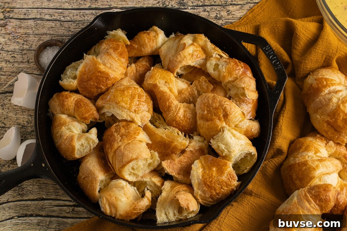 torn up croissants in a cast iron skillet