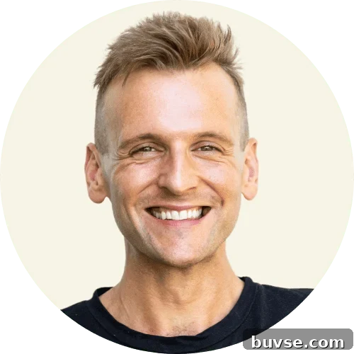 Kaleb Wyse wearing a black shirt standing in front of a taupe background.