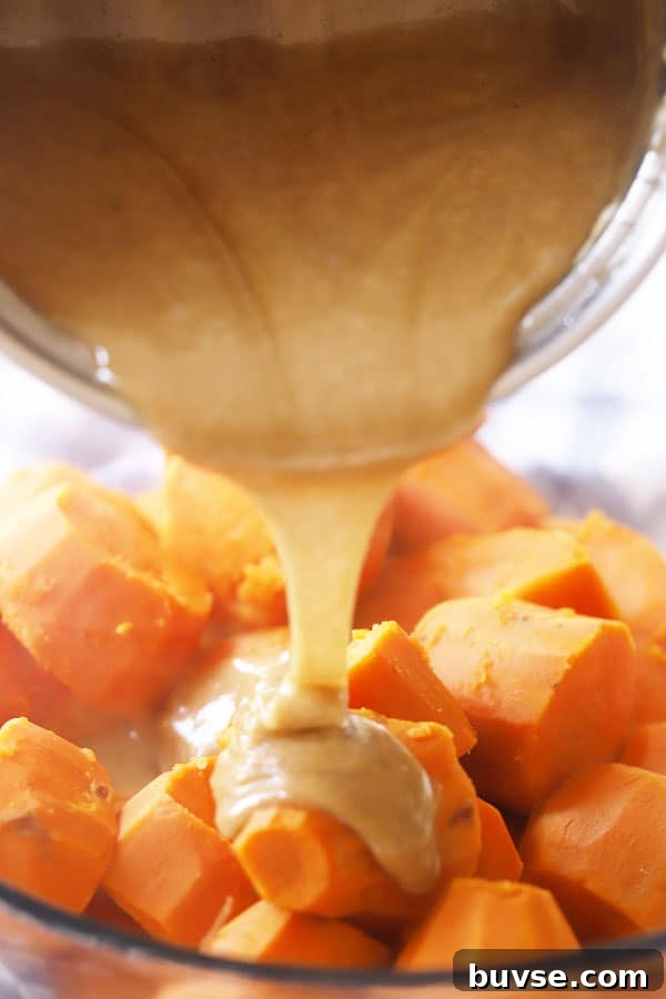 Sweet Potato Casserole with Toasted Marshmallows Recipe 3 Pouring the brown sugar caramel mixture over cooked sweet potatoes.