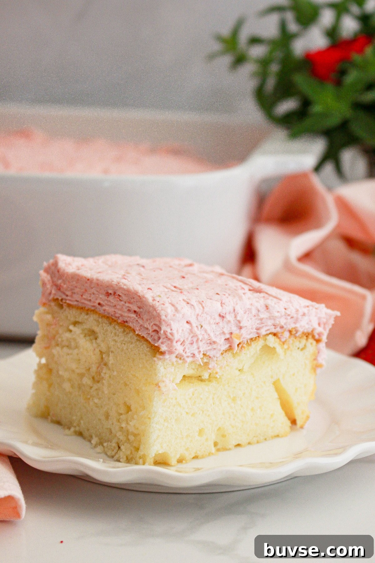 Vanilla Sheet Cake Recipe with Strawberry Frosting 2 Slice of cake on a small plate.