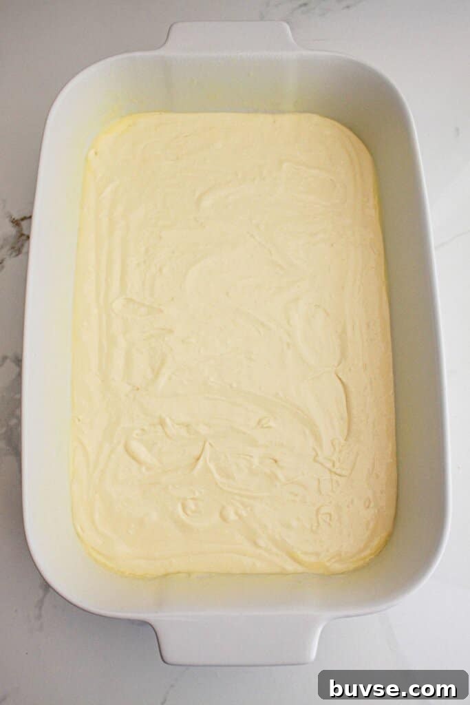 Vanilla Sheet Cake Recipe with Strawberry Frosting 6 Cake batter in a baking dish.