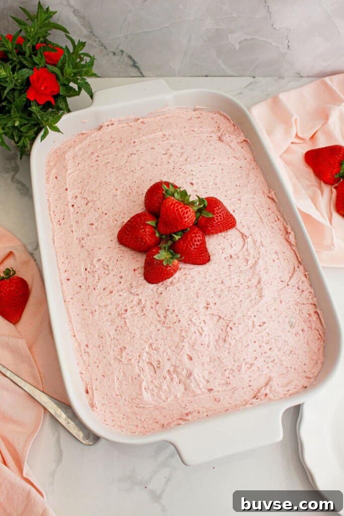 Vanilla Sheet Cake Recipe with Strawberry Frosting 10 Slice of cake on a small plate.