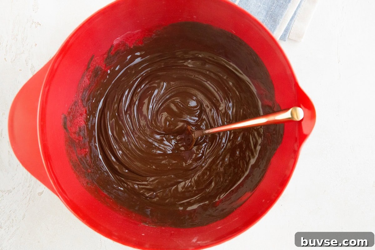 Chocolate ganache layer for peanut butter bars in a mixing bowl